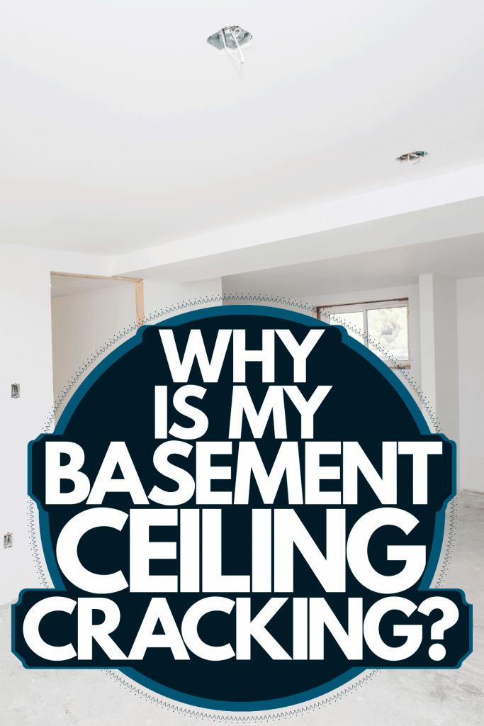 A white unfinished basement with recessed lighting and windows, Why Is My Basement Ceiling Cracking?