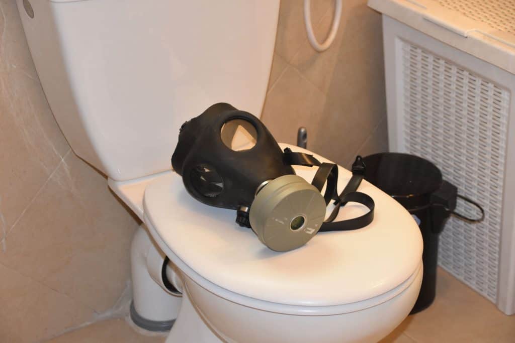 A gas mask placed on the toilet cover