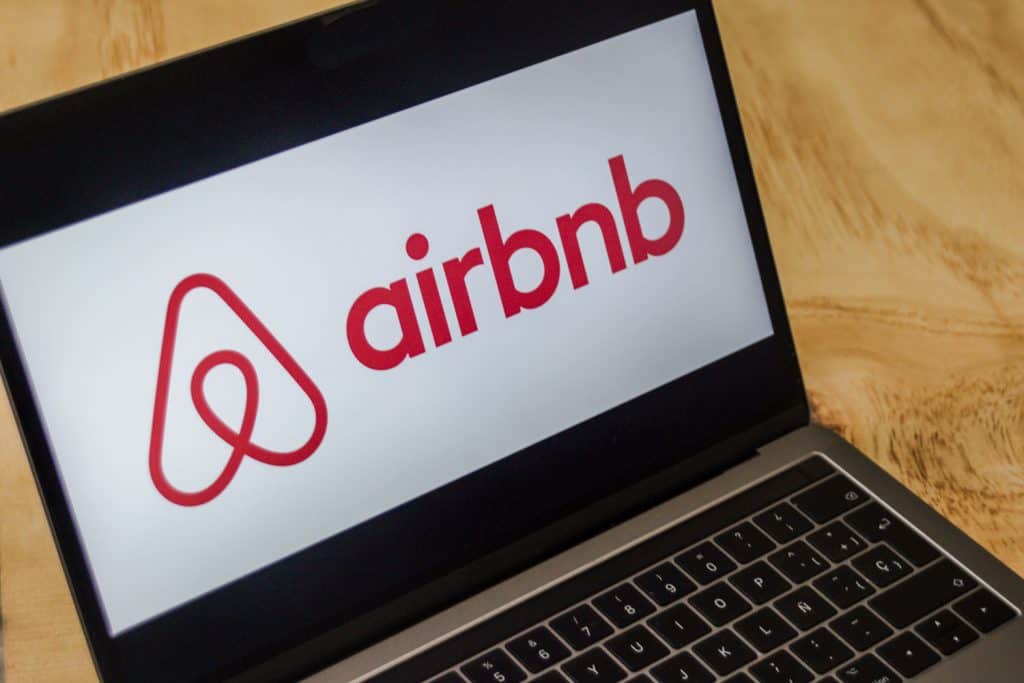 The Airbnb logo on the laptop screen