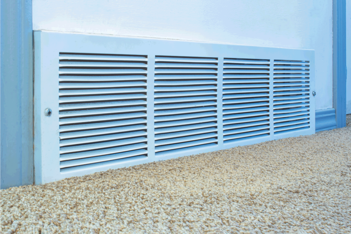 Cold air return vent Inside residencial home, air vent on a white wall with carpet.
