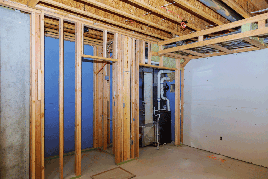 Interior frame of a new basement house under construction. What Wood To Use For Framing A Basement