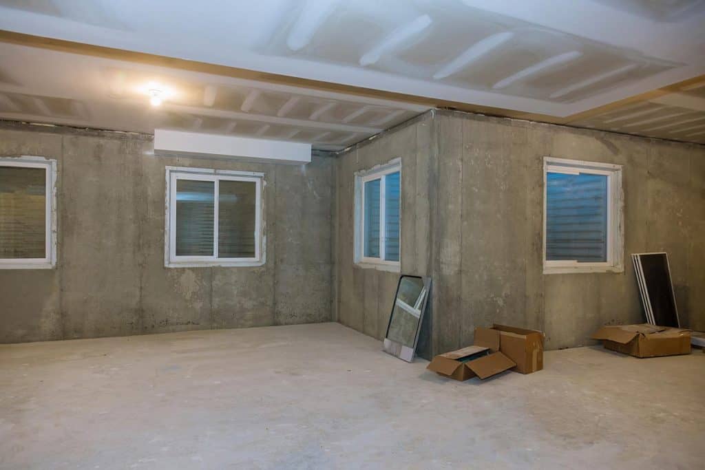 Unfinished concrete floor construction of basement