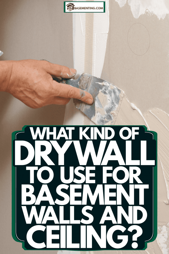 A worker using a small trowel in plastering the holes of the drywall, What Kind Of Drywall To Use For Basement Walls And Ceiling?