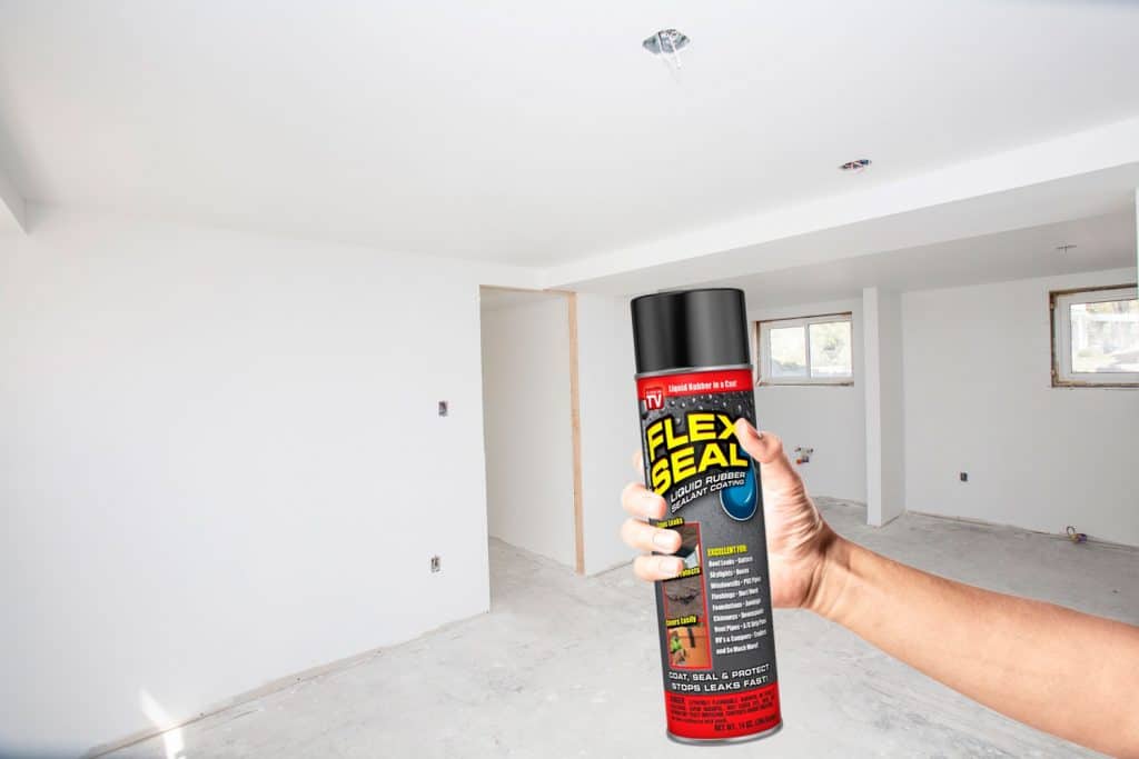 A large basement gets a renovation with man's hand holding flex seal, Can You Use Flex Seal To Waterproof A Basement?