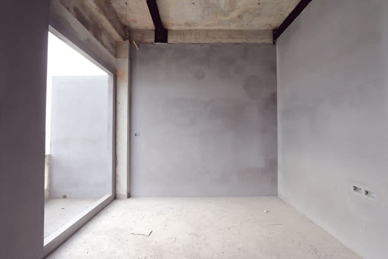 An unfinished basement room under construction, How To Clean A Dusty Concrete Basement Floor? [Plus Tips to Reduce Dust Buildup]