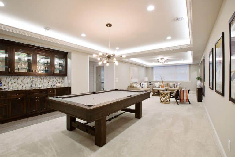 Beautiful basement entertaining room with LED lighting in tray ceiling, How Much Lighting Do You Need For A Basement?