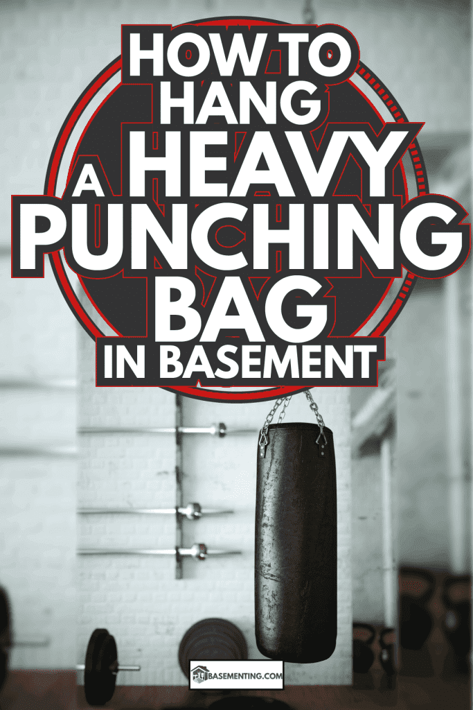Black leather punching bag in empty room. How To Hang A Heavy Punching Bag In Basement
