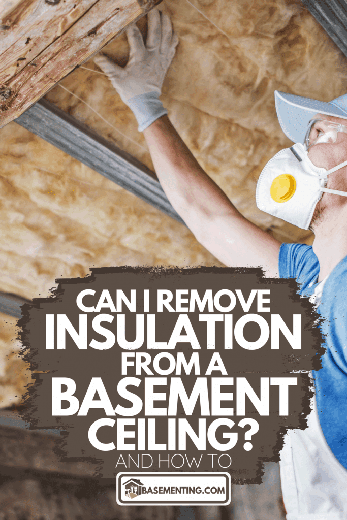 A worker holding wool insulator, Can I Remove Insulation From A Basement Ceiling? [And How To]