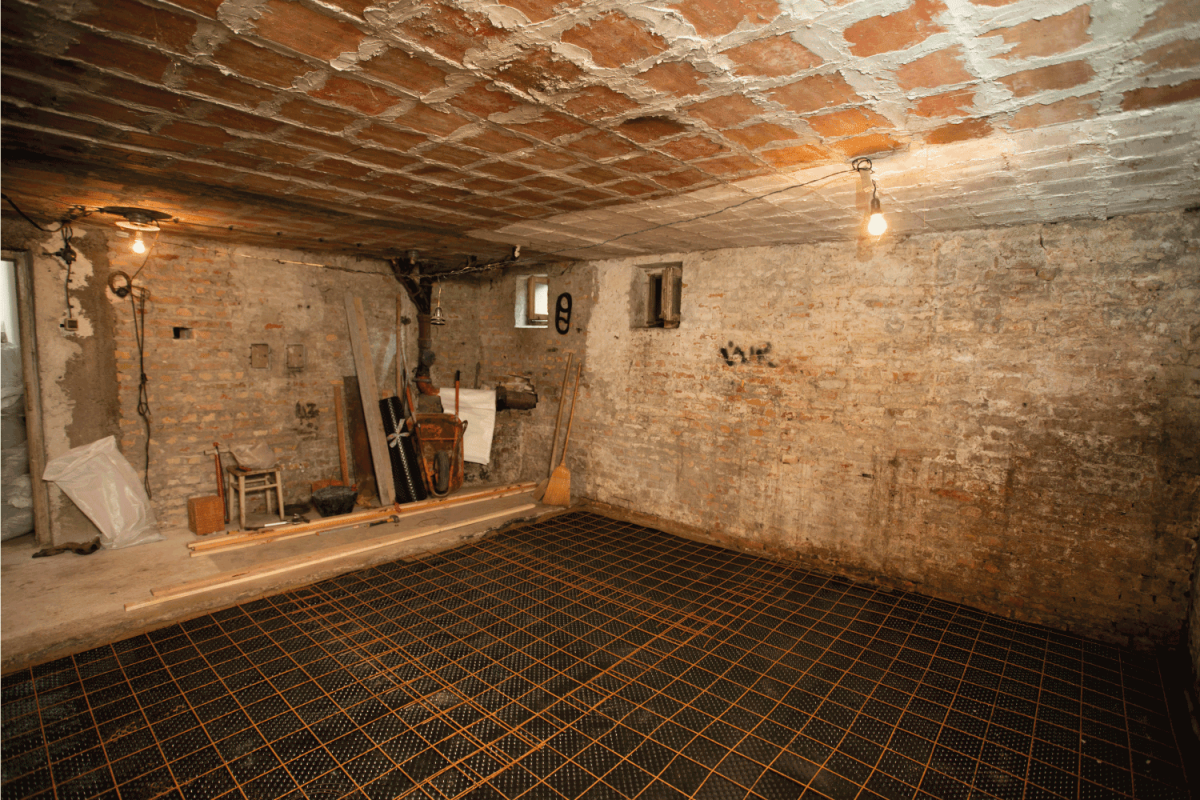basement room renovation, peeled of wall finishing, rebar on the flooring