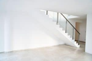 A concrete basement stairwell with metal railing, Should Basement Stairwell Be Open?