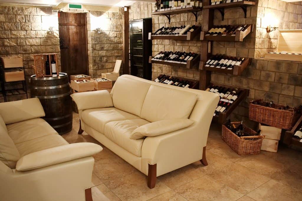 A homey and elegant wine cellar with a tall wine rack on the back