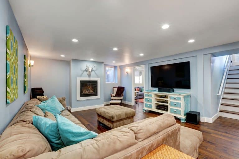 A nicely refurbished basement room with white painted ceiling, recessed lighting and wooden flooring, Can I Dig Below My Basement