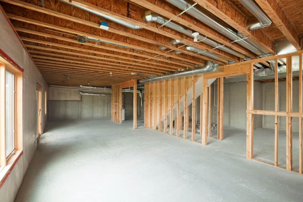 An unfinished walk out basement in a large two story or ranch house