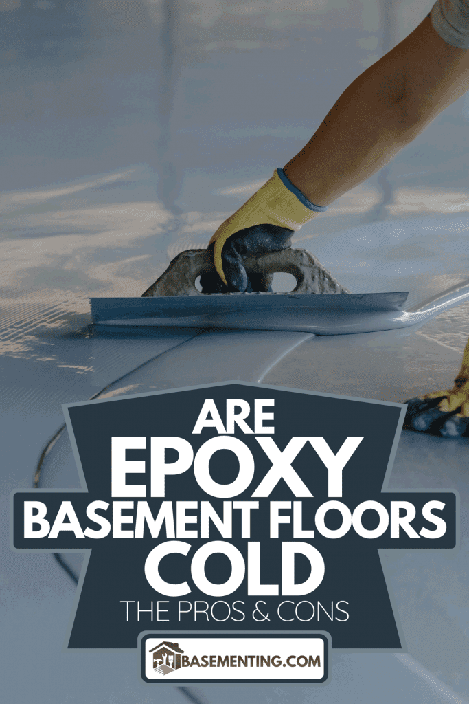 A worker applies gray epoxy resin to the new floor, Are Epoxy Basement Floors Cold: The Pros & Cons