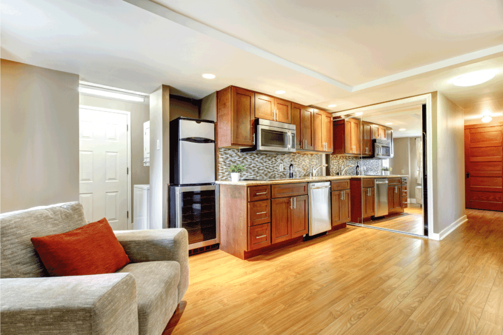 Basement luxury kitchen in the modern apartment with hardwood floors. Can You Put A Kitchen In A Basement