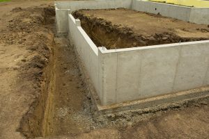 Concrete footings and basement walls finished ready for next phase of new home construction, Do Basements Have Footings? [Your Guide To Basic Basement Construction]