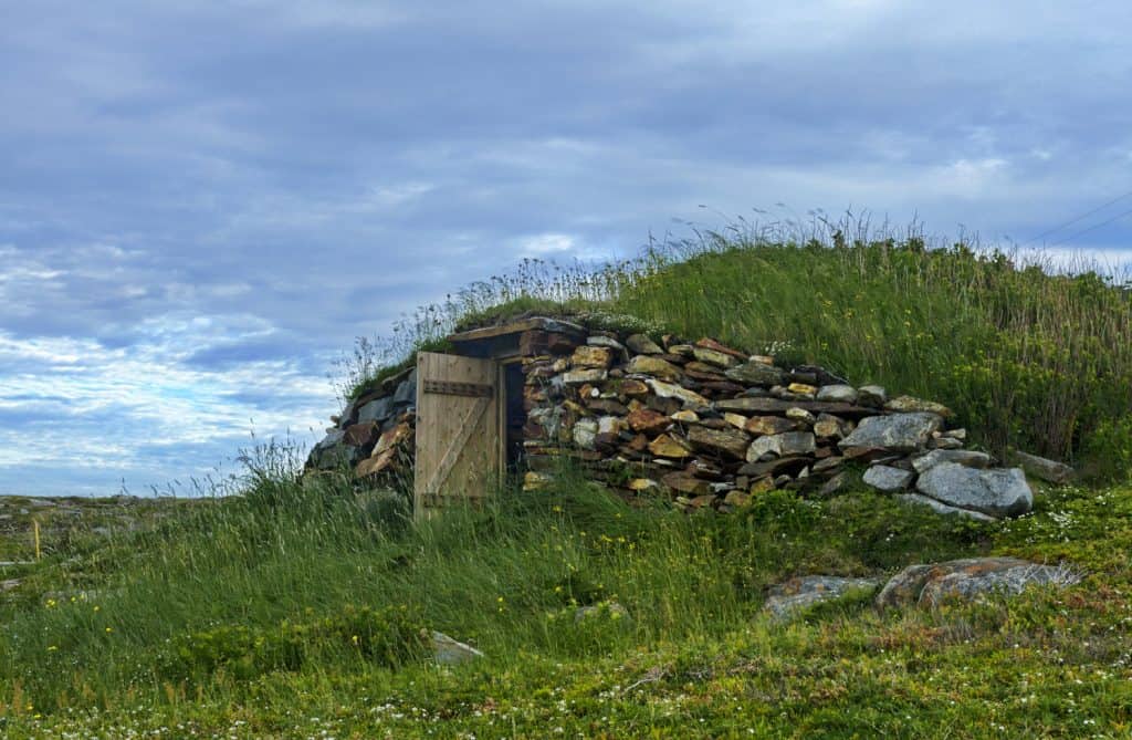 Door is open on rustic, underground root cellar in Elliston on Bonavista Peninsula in Newfoundland, Canada. Destination is Root Cellar Capital of the World.

