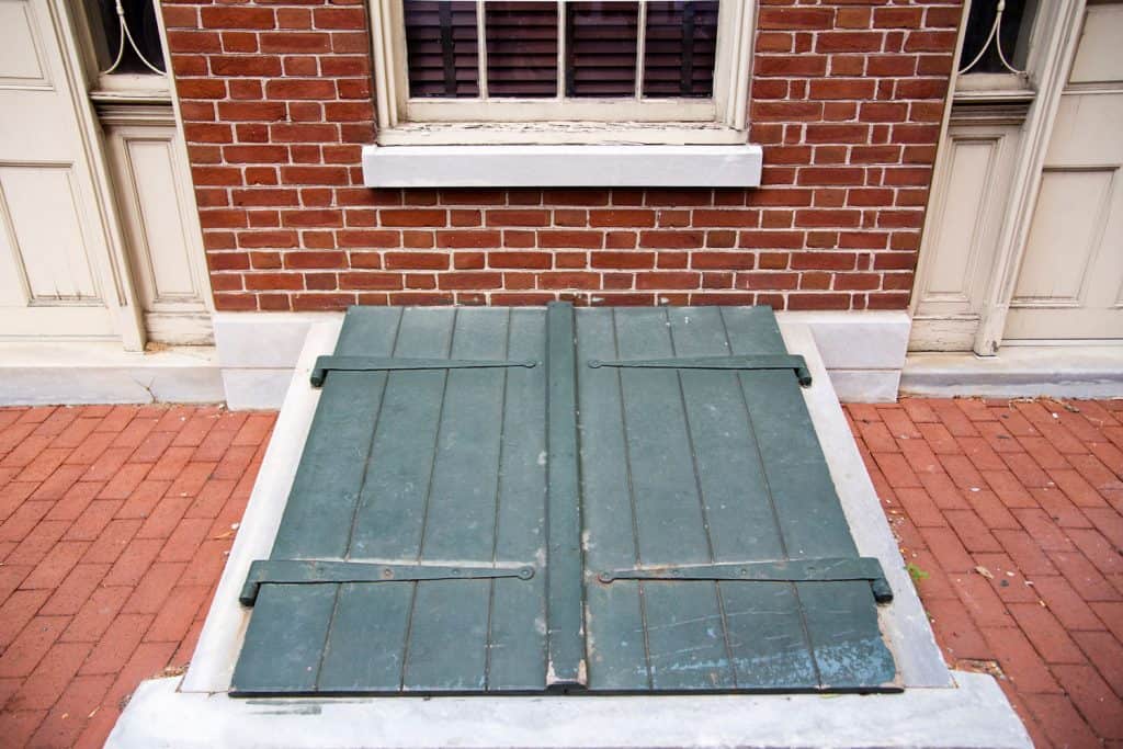 Green basement doors outside a brick home, How To Measure For A Bilco Basement Door