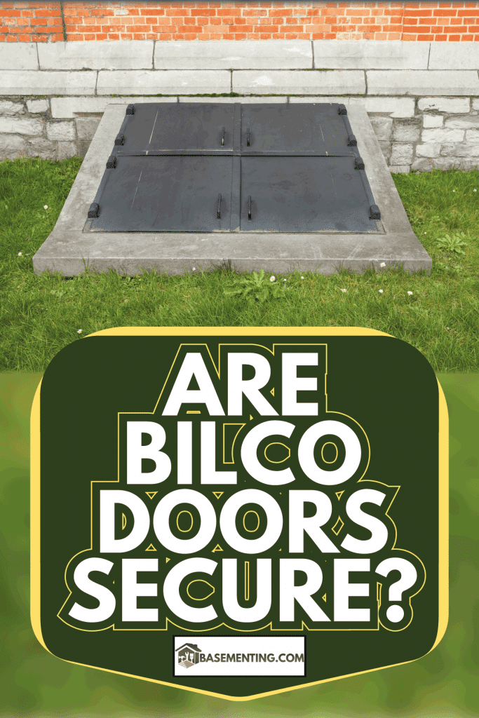 In the grass next to a brick wall house is this iron door to the basement. Are Bilco Doors Secure