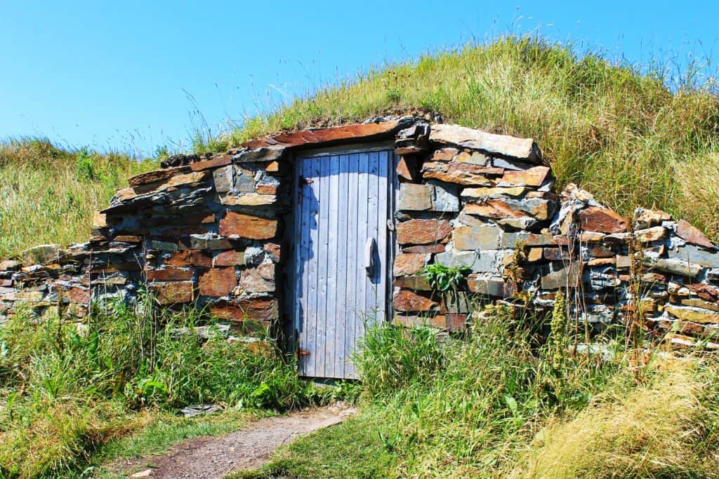 Old stone root cellar with a wooden door, Elliston, Newfoundland.

