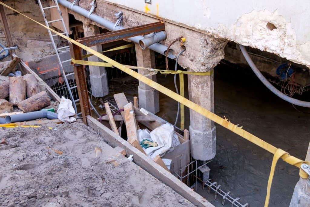 Repair work on the foundation of a building on concrete poles
