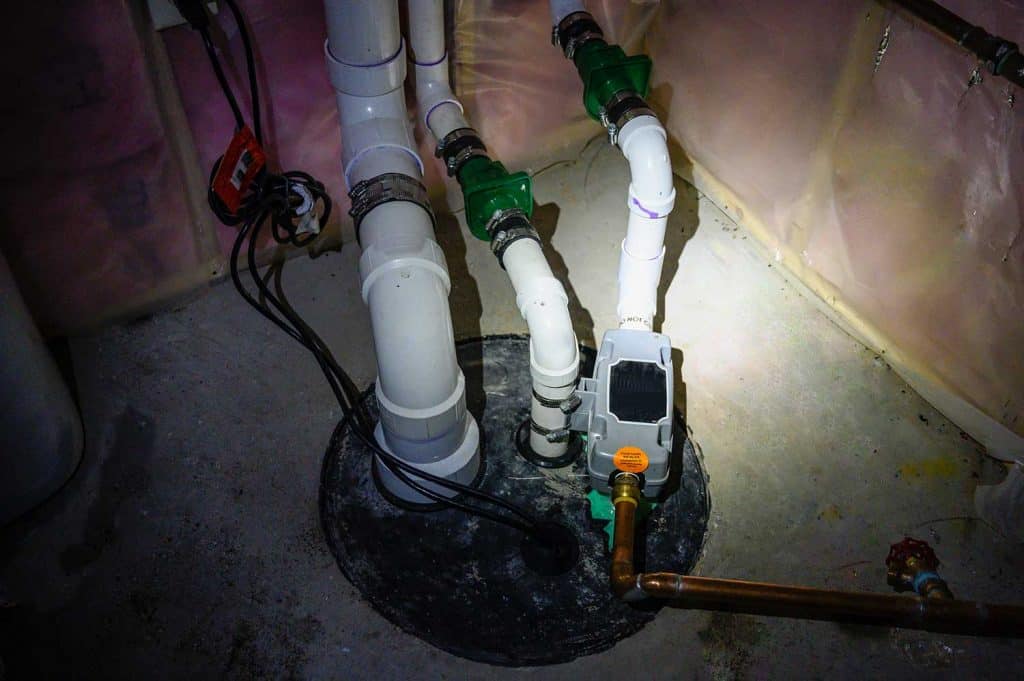 Sump pump manhole with water backup viewed with a flashlight