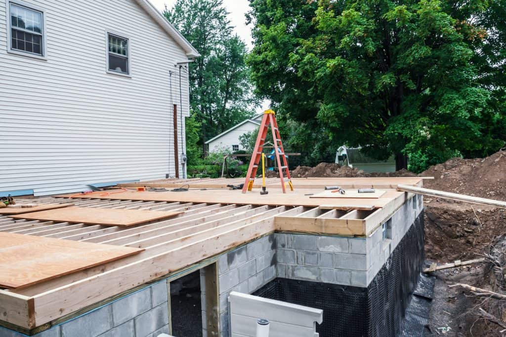 The subfloor covering a new home addition basement foundation