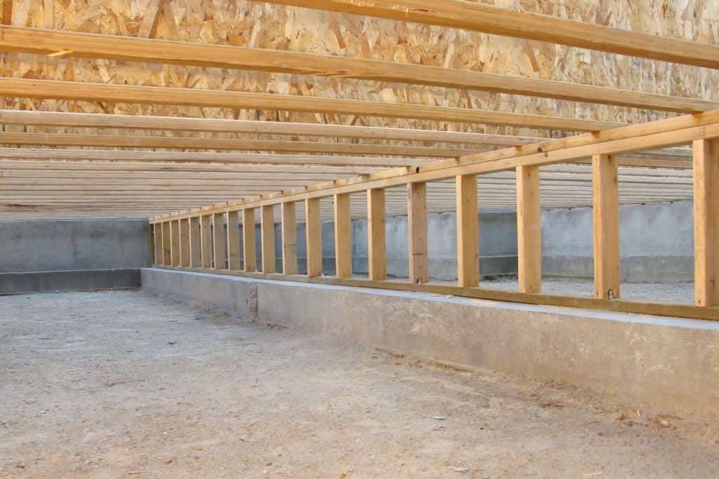Wooden framing and floor joist under a crawlspace of a small house