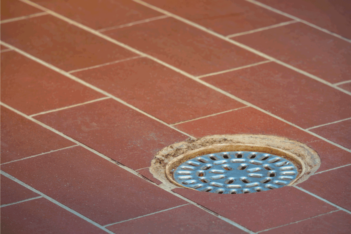 brown tiled floor with floor drain