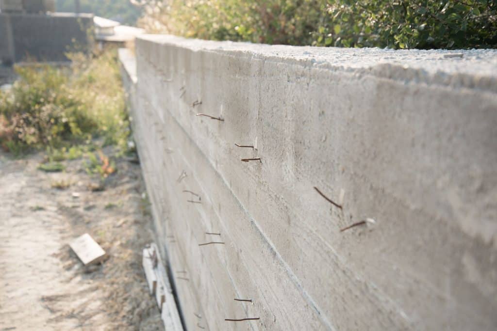 A wall with metal extensions sticking out