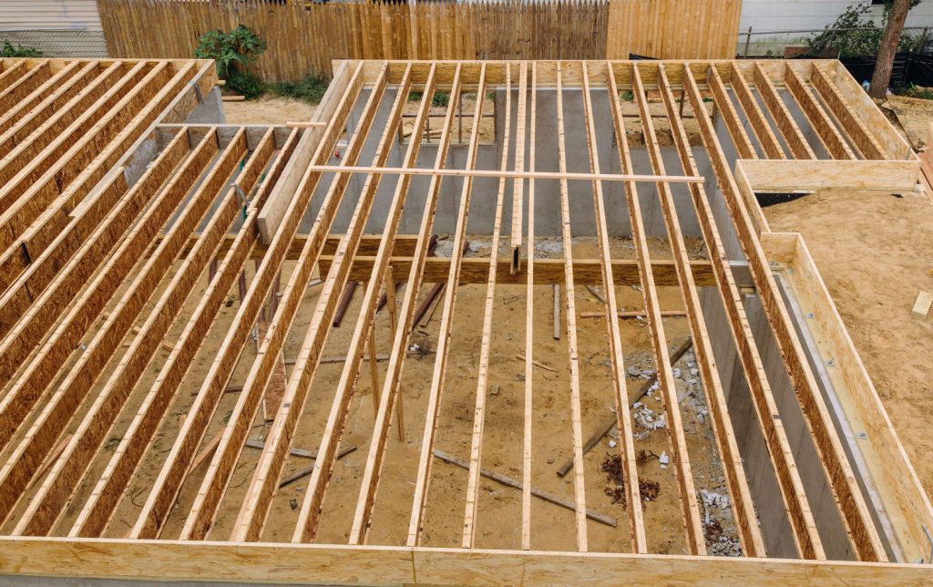 House framing floor construction showing massive solid wood joists trusses
