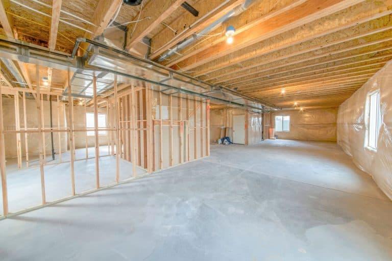 Unfinished basement interior with woodframes and windows, How Long Will A Wood Basement Last?