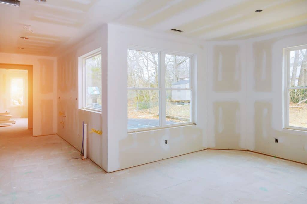 Unfinished drywall installation with visible plastering lines